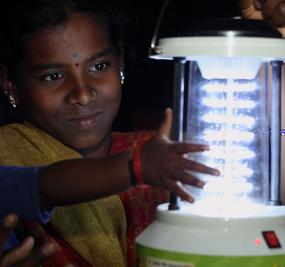 rural-electrification-village-women-and-child-with -lamp