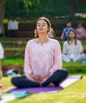 group meditation in lawn girl smiling at blr ashram