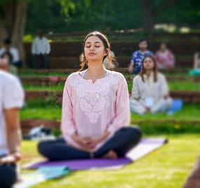 group meditation in lawn girl smiling at blr ashram