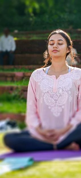 group meditation in lawn girl smiling at blr ashram