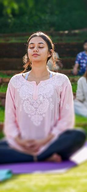 group meditation in lawn girl smiling at blr ashram