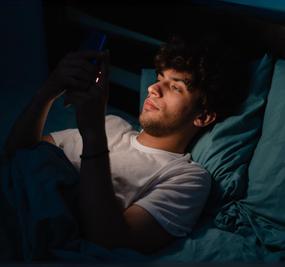 Meditation to break bad habits man scrolling on mobile while sleeping