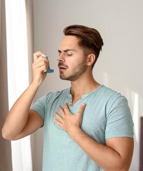 Healing Asthma with Ayurveda man with inhaler