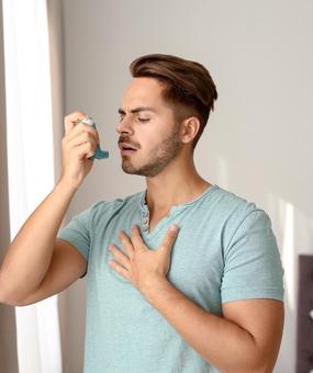 Healing Asthma with Ayurveda man with inhaler