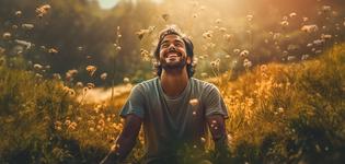 A happy smiling man in middle of flower garden