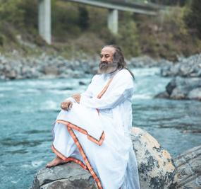 Gurudev sitting on rock on the bank of Ganga