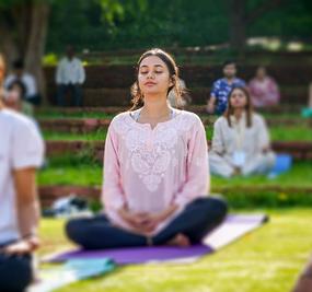 group meditation in lawn girl smiling at blr ashram